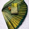 A "one gram gold trending tissue saree" typically refers to a saree made from a lightweight, sheer fabric known as tissue - BOTTLE GREEN