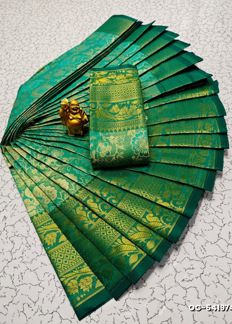 A "one gram gold trending tissue saree" typically refers to a saree made from a lightweight, sheer fabric known as tissue - EMERALD COLOUR